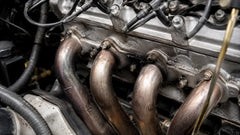 Header gasket leak with black soot around the exhaust header flange