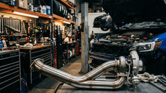 stainless steel downpipe exhaust in a garage
